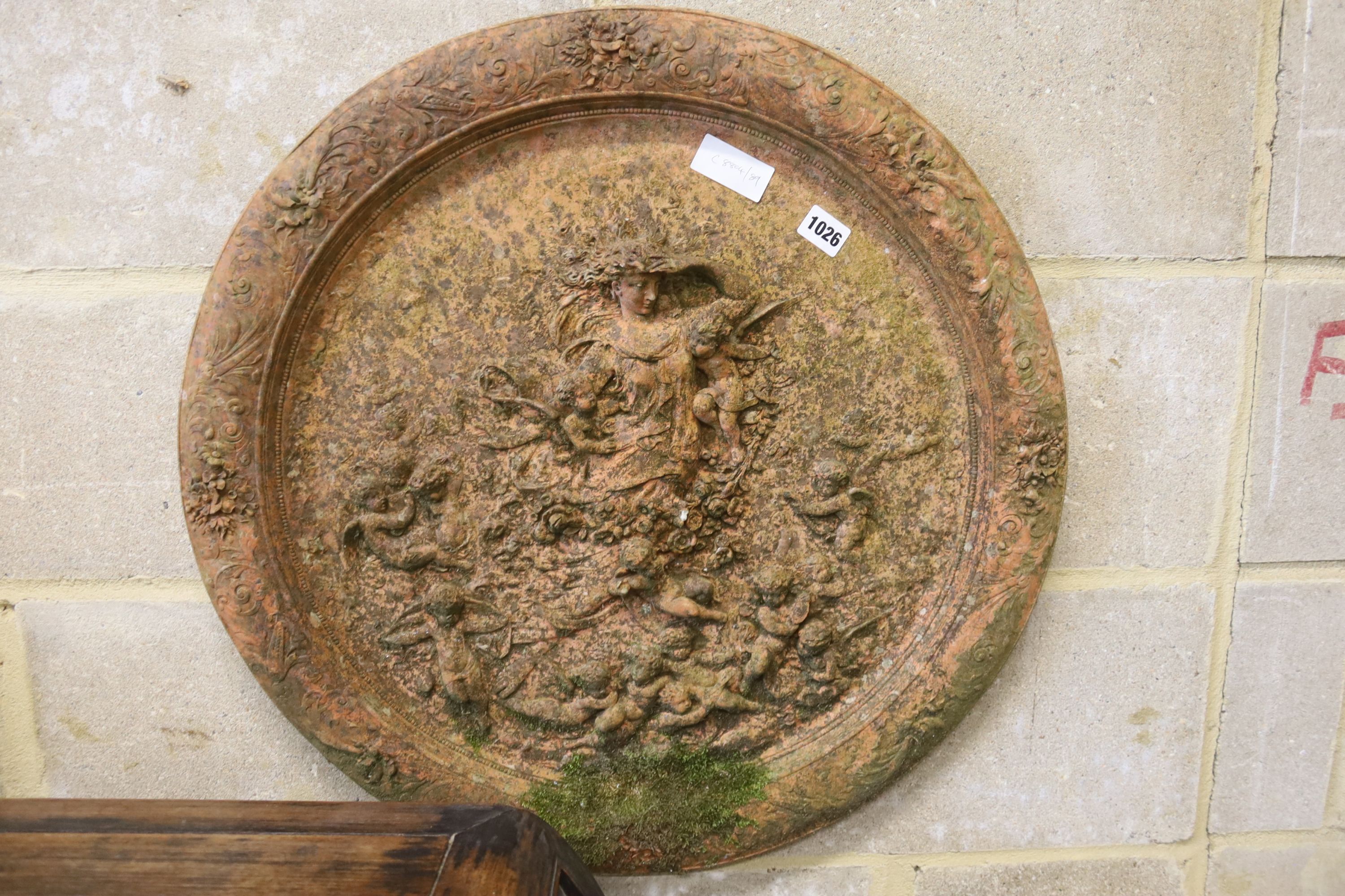A circular terracotta garden wall plaque, diameter 62cm